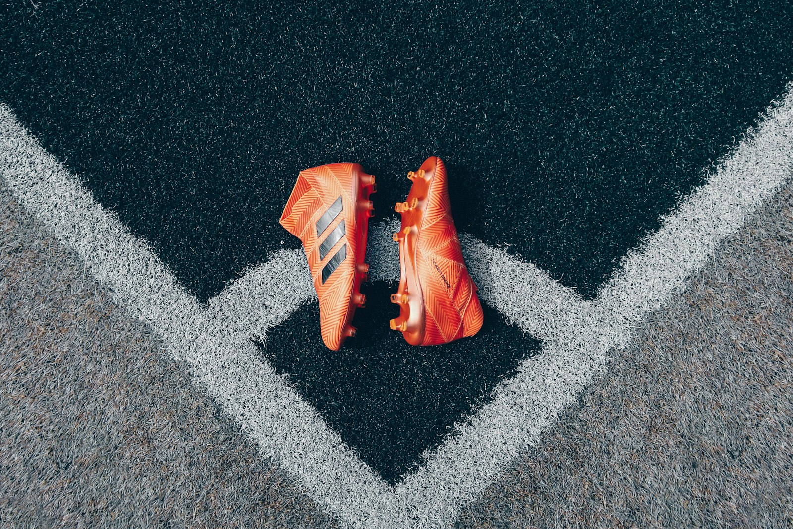 Football boots on a pitch line